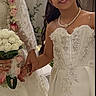 bouquet, bride, celebration, ceremony, child, dress, floral_arrangement, flowers, formalwear, girl, gown, indoors, jewelry, long_hair, necklace, portrait, smiling, tiara, wedding, white_dress