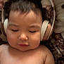 Amaia joined the competition — help win amazing prizes! toddler, child, headphones, bare_chest, sleeping, indoors, blanket, soft_lighting, cozy, relaxed, young_child, face, hair, person, resting, cute, infant, peaceful, comfort, portrait