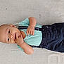 baby, child, infant, toddler, smiling, clothing, shorts, shirt, suspenders, hand, fingers, lying_down, floor, cute, happy, skin, head, face, eyes, mouth