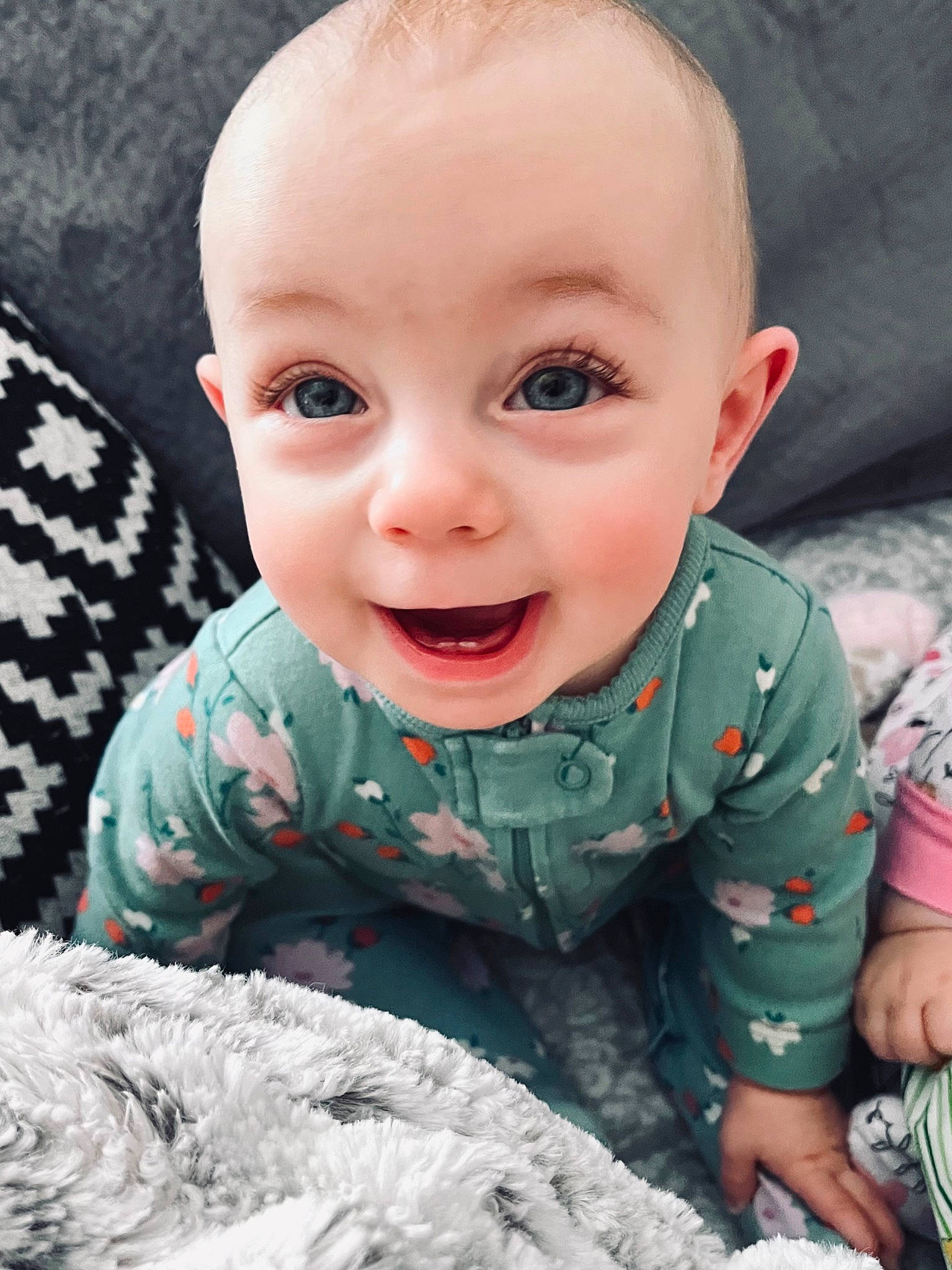 Norah is registered to the contest to win money with this photo: baby, baby_toddler_clothing, cheek, comfort, eye, face, facial_expression, fun, gesture, hairstyle, happy, joy, mouth, nose, organ, person, pink, product, skin, sleeve