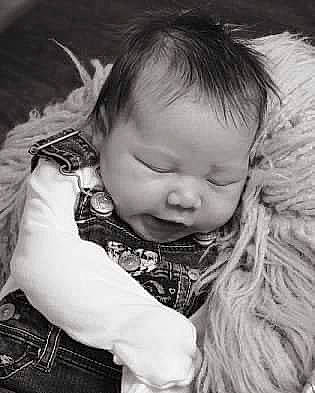 Madelynn is registered to the contest to win money with this photo: baby, black, cheek, eye, eyelash, face, flash_photography, hairstyle, happy, head, iris, lip, mouth, nose, organ, outerwear, person, skin, sleeve, tartan