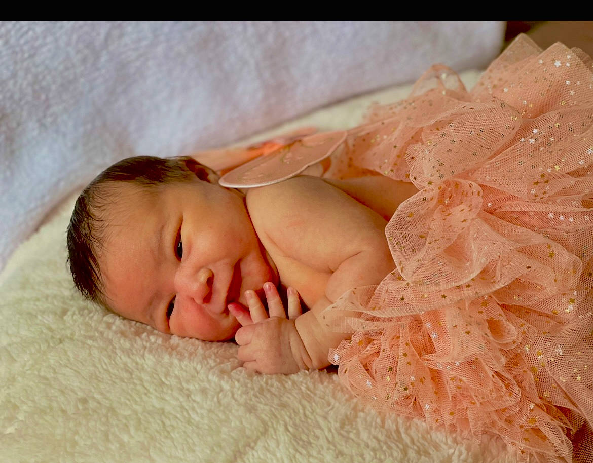 Madelynn is registered to the contest to win money with this photo: baby, baby_sleeping, baby_toddler_clothing, bedding, bedtime, child, comfort, embellishment, fashion_accessory, flesh, fur, grass, headgear, linens, nap, peach, person, portrait_photography, sleep, toddler