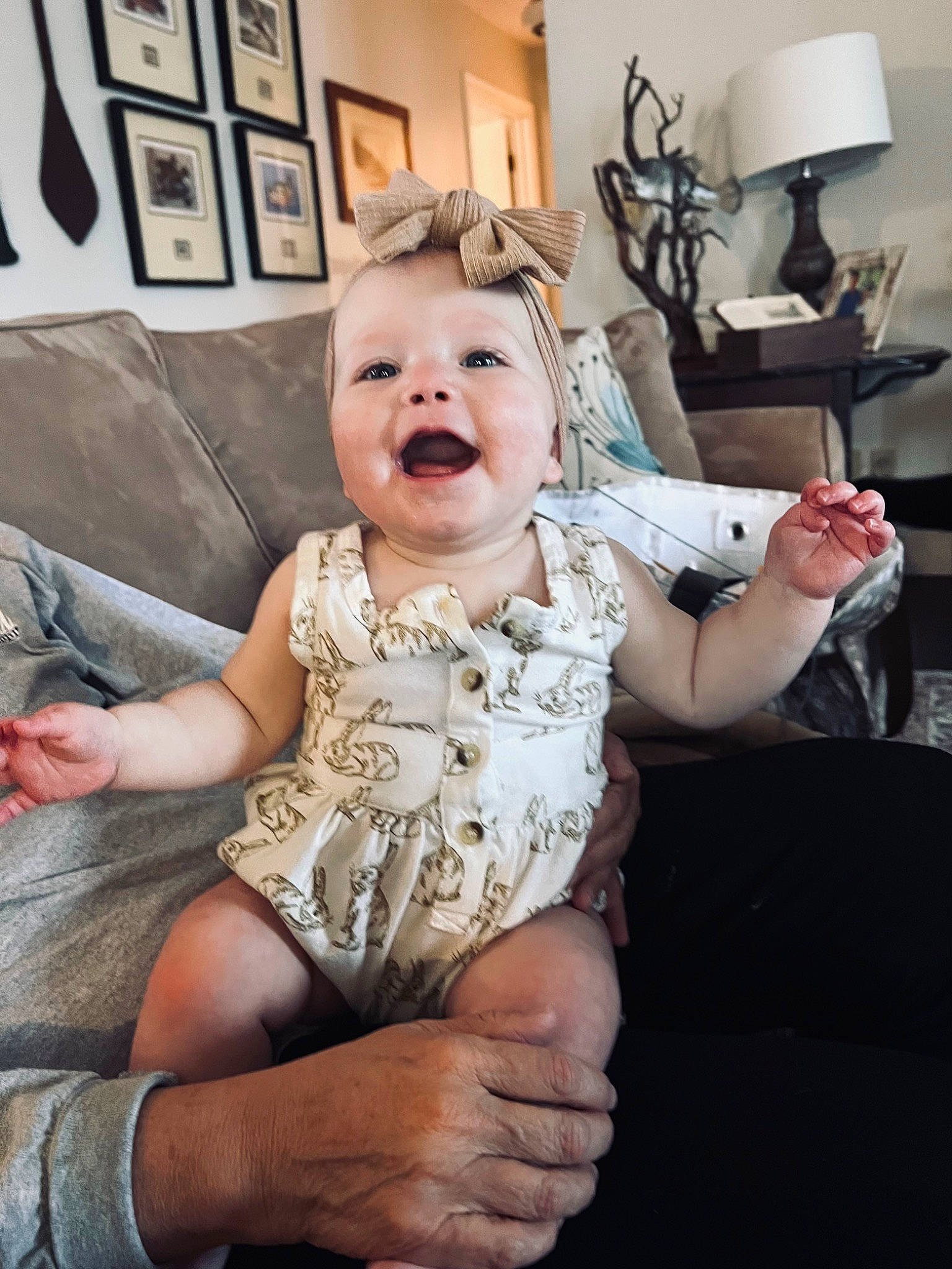 Hadley is registered to the contest to win money with this photo: baby, baby_toddler_clothing, chair, child, comfort, couch, event, facial_expression, flash_photography, flooring, fun, gesture, hairstyle, happy, lamp, person, picture_frame, sitting, skin, smile