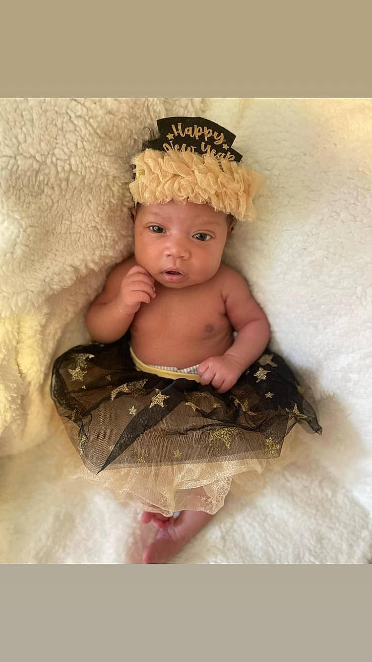 Mya Amour is registered to the contest to win money with this photo: baby, baby_toddler_clothing, bridal_accessory, costume, costume_hat, dress, embellishment, fashion_accessory, flash_photography, hair_accessory, hand, happy, headband, headgear, headpiece, headwear, iris, jewellery, peach, person