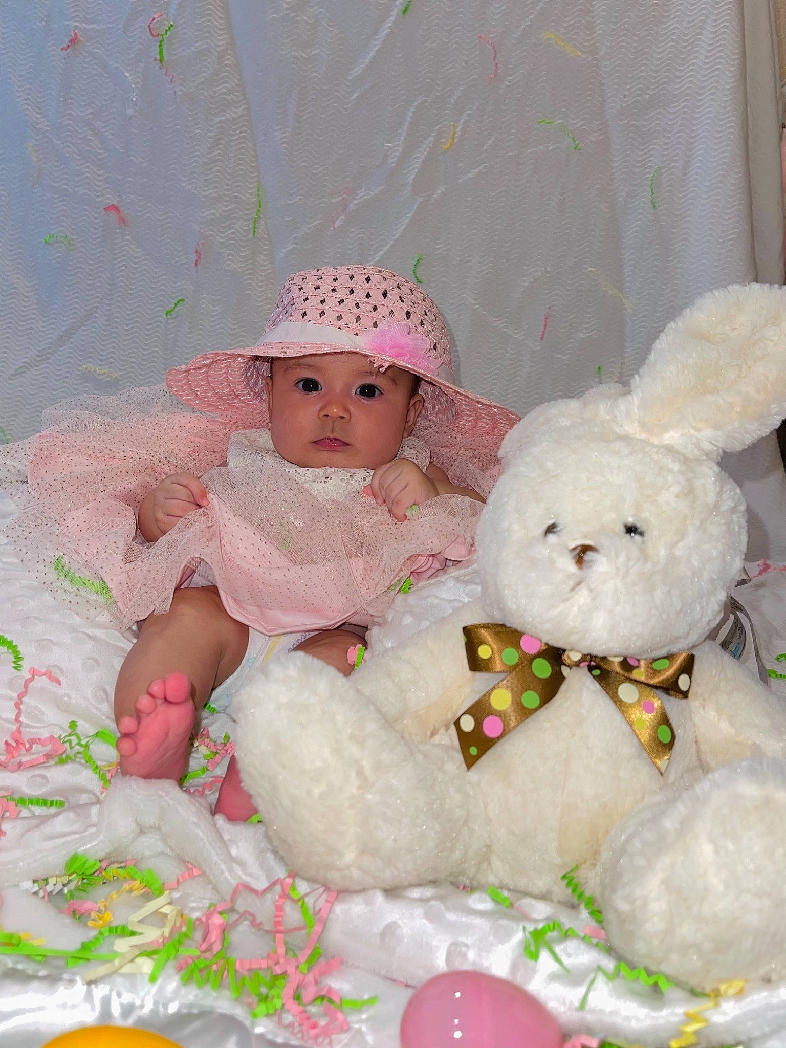 Samantha joined the competition — help win amazing prizes! baby, baby_toddler_clothing, baby_toys, beanie, cap, child, doll, fashion_accessory, headgear, headwear, knit_cap, linens, pattern, person, pink, room, sitting, teddy_bear, textile, toddler