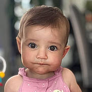 Harper is registered to the contest to win money with this photo: baby, child, closeup, cute, expression, eyes, face, focus, hair, hand, head, indoor, infant, person, pink_clothing, portrait, sitting, skin, soft_background, young_child