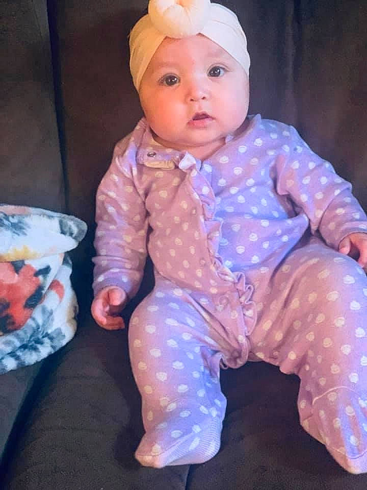 Marloe is registered to the contest to win money with this photo: baby, baby_toddler_clothing, cap, cheek, child, costume_hat, doll, electric_blue, eye, head, headwear, human_body, magenta, pattern, person, pink, purple, skin, sleeve, textile