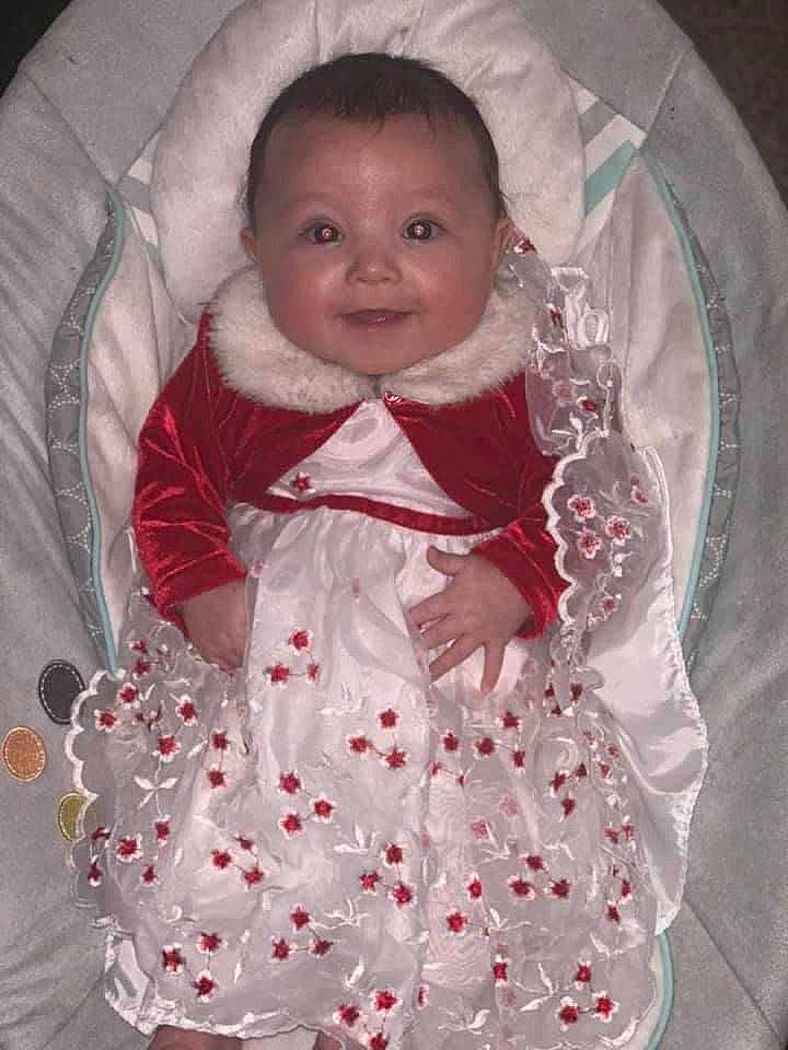 Marloe is registered to the contest to win money with this photo: baby, baby_carriage, baby_products, baby_toddler_clothing, cheek, child, comfort, dress, face, happy, head, human_body, joy, linens, pattern, person, pink, sitting, sleeve, smile