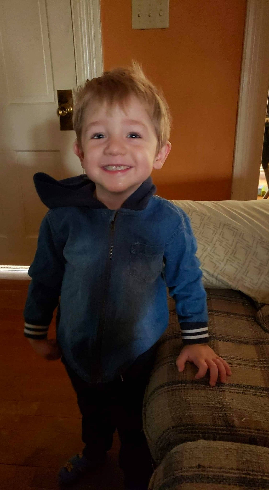 Jack is registered to the contest to win money with this photo: arm, baby_toddler_clothing, cheek, comfort, finger, floor, flooring, happy, hardwood, joint, joy, leg, neck, nose, person, shoulder, skin, sleeve, smile, toddler