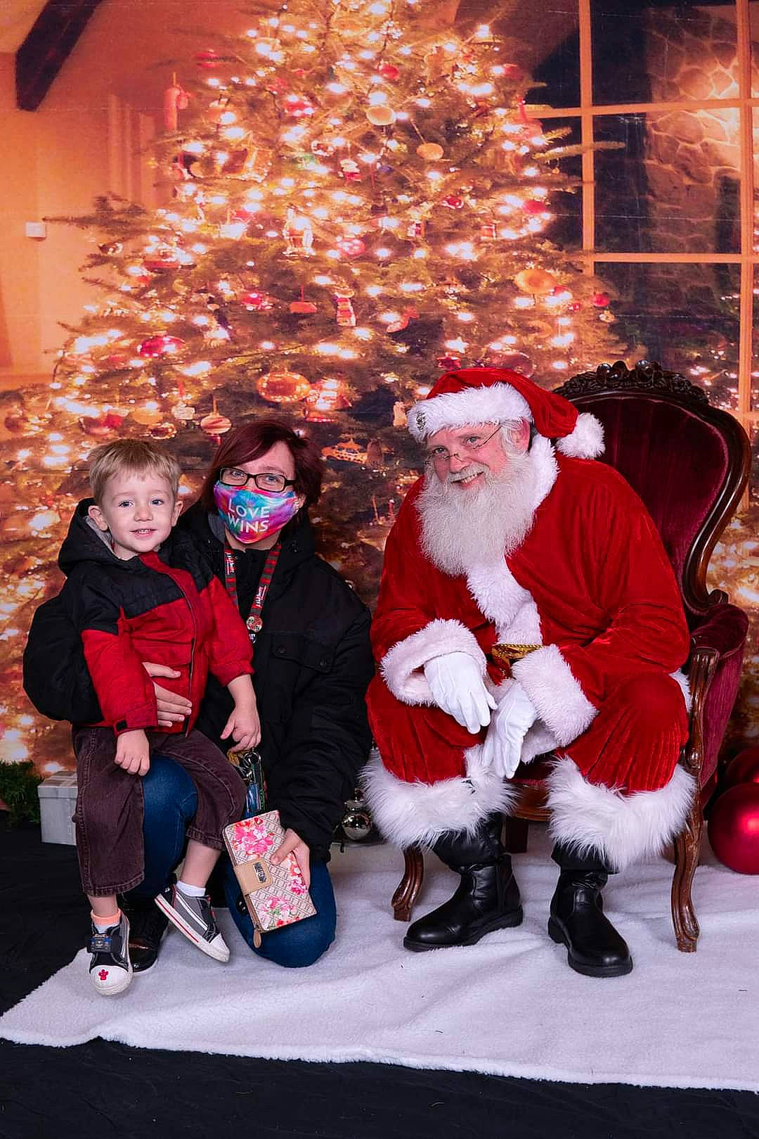 Jack joined the competition — help win amazing prizes! beard, christmas, christmas_decoration, christmas_ornament, christmas_tree, facial_expression, fun, hat, headwear, holiday, holiday_ornament, joy, lap, person, plant, red, santa_claus, smile, social_group, standing