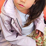 Jade a rejoint le concours — aidez-le/la à gagner de superbes lots ! casual_clothing, child, cobblestone, curious, daylight, expression, face, floral_skirt, girl, outdoor, pigtails, pink, portrait, raincoat, sitting, sneakers, street, toy_vehicle, white_tights, young_child
