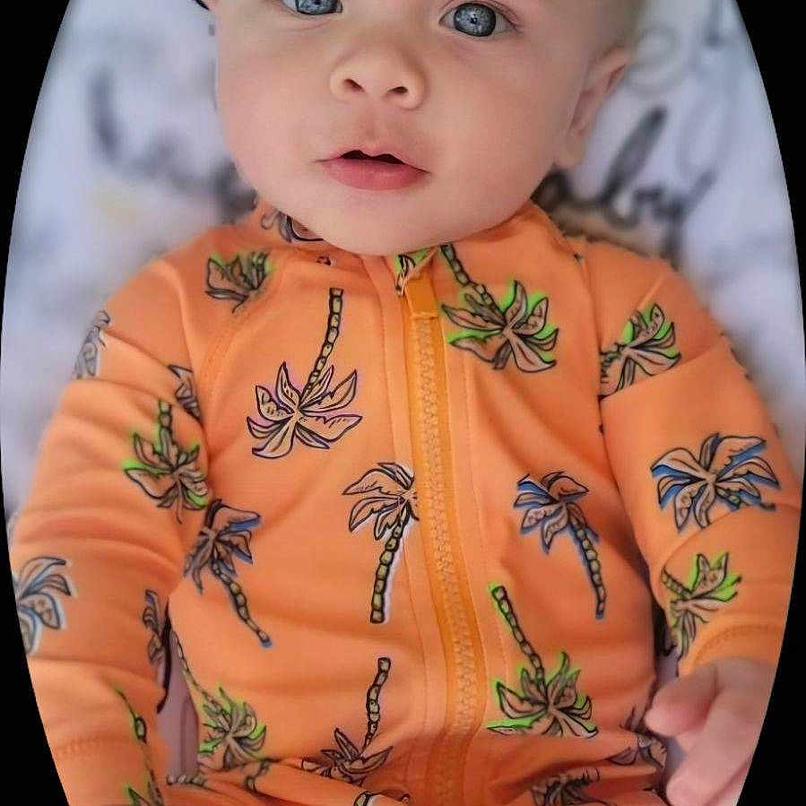 Dalton is registered to the contest to win money with this photo: baby, bodypart, clothing, coat, dress, face, finger, fisheye, hand, happy, head, jacket, newborn, pattern, person, photography, portrait, skin, smile, tattoo