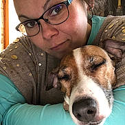 Judy participe au concours pour gagner de l'argent avec cette photo : affection, brown_dog, casual_clothing, close_up, dog, eyewear, face, glasses, happy, hugging, human, indoor, pet, portrait, relaxed, sleeping_dog, snuggling, warm_light, white_dog, woman