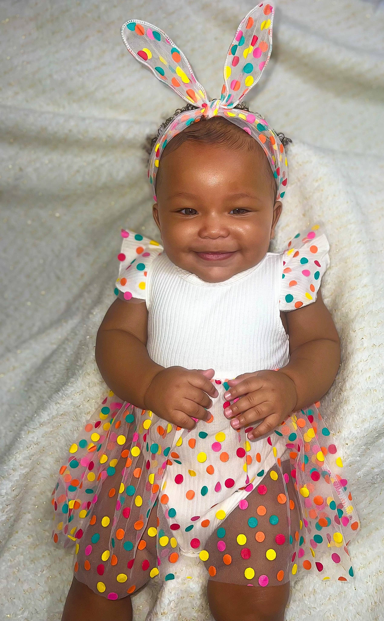 Raiyn is registered to the contest to win money with this photo: baby, baby_toddler_clothing, child, costume_hat, dress, face, facial_expression, green, happy, head, headgear, headpiece, joy, person, pink, skin, sleeve, smile, t_shirt, textile