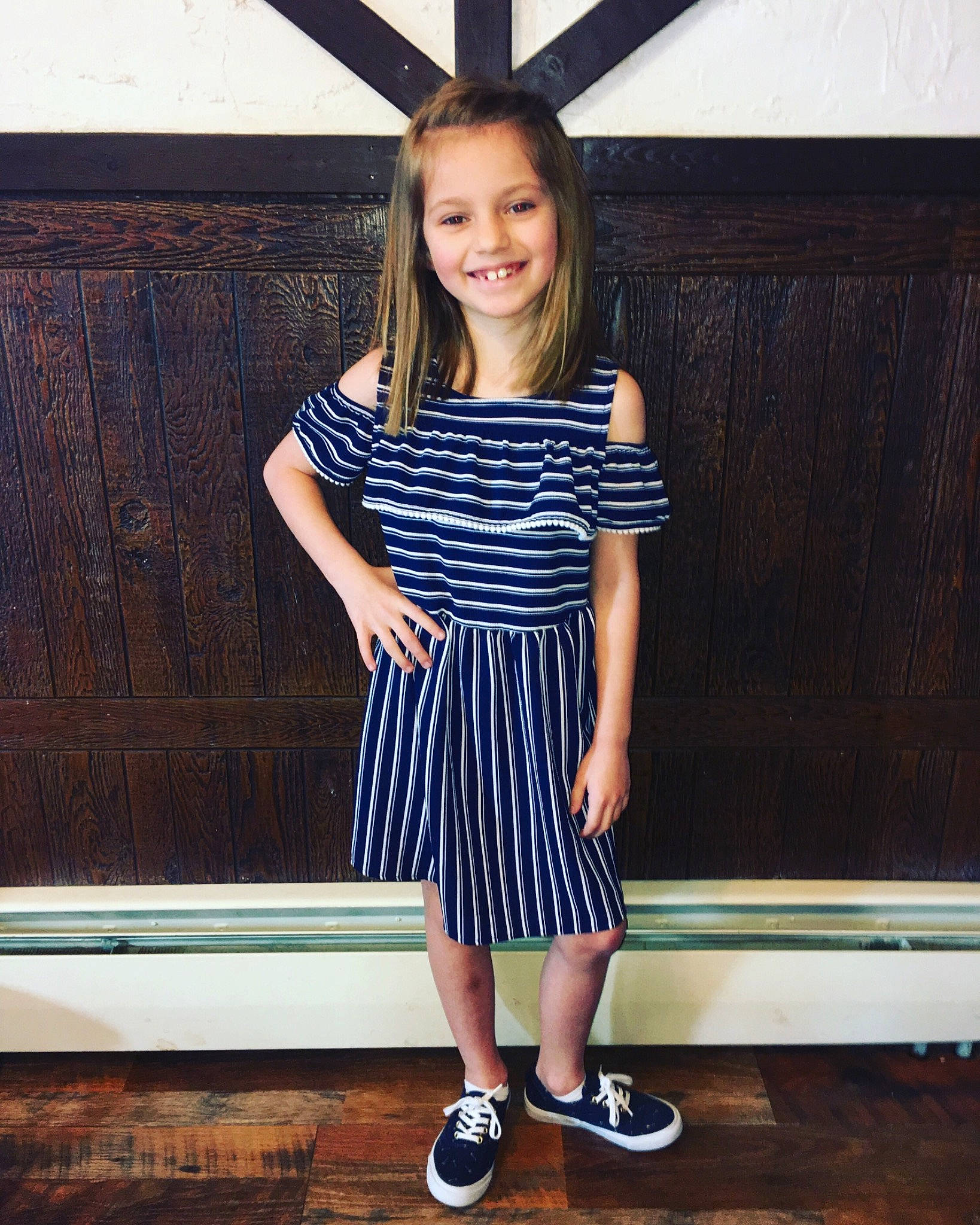 Micaela is registered to the contest to win money with this photo: blue, child, child_model, clothing, design, dress, electric_blue, footwear, joy, pattern, person, shoe, shoulder, sleeve, smile, standing, t_shirt, toddler, waist