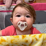 Isabelle joined the competition — help win amazing prizes! baby, pacifier, blanket, plush_toy, stuffed_bunny, yellow_toy, wooden_wall, pink_clothing, indoor, child, face, curly_hair, cute, infant, soft_toy, bedroom, playpen, expression, childhood, toy