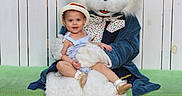 Nita is registered to the contest to win money with this photo: bench, bunny_costume, child, costume, family_event, fence, floral_background, flowers, grass, green_cushion, hat, holiday_photo, mascot, outdoor, person, plush, portrait, sitting, smile, toddler