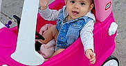 Nita is registered to the contest to win money with this photo: baby, blanket, child, concrete, cute, denim_jacket, little_tikes, outdoor, pink_car, plastic_toy, playtime, portrait, sidewalk, smile, steering_wheel, toddler, tongue_out, toy_car, waving, wheel