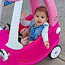 Nita is registered to the contest to win money with this photo: baby, blanket, child, concrete, cute, denim_jacket, little_tikes, outdoor, pink_car, plastic_toy, playtime, portrait, sidewalk, smile, steering_wheel, toddler, tongue_out, toy_car, waving, wheel