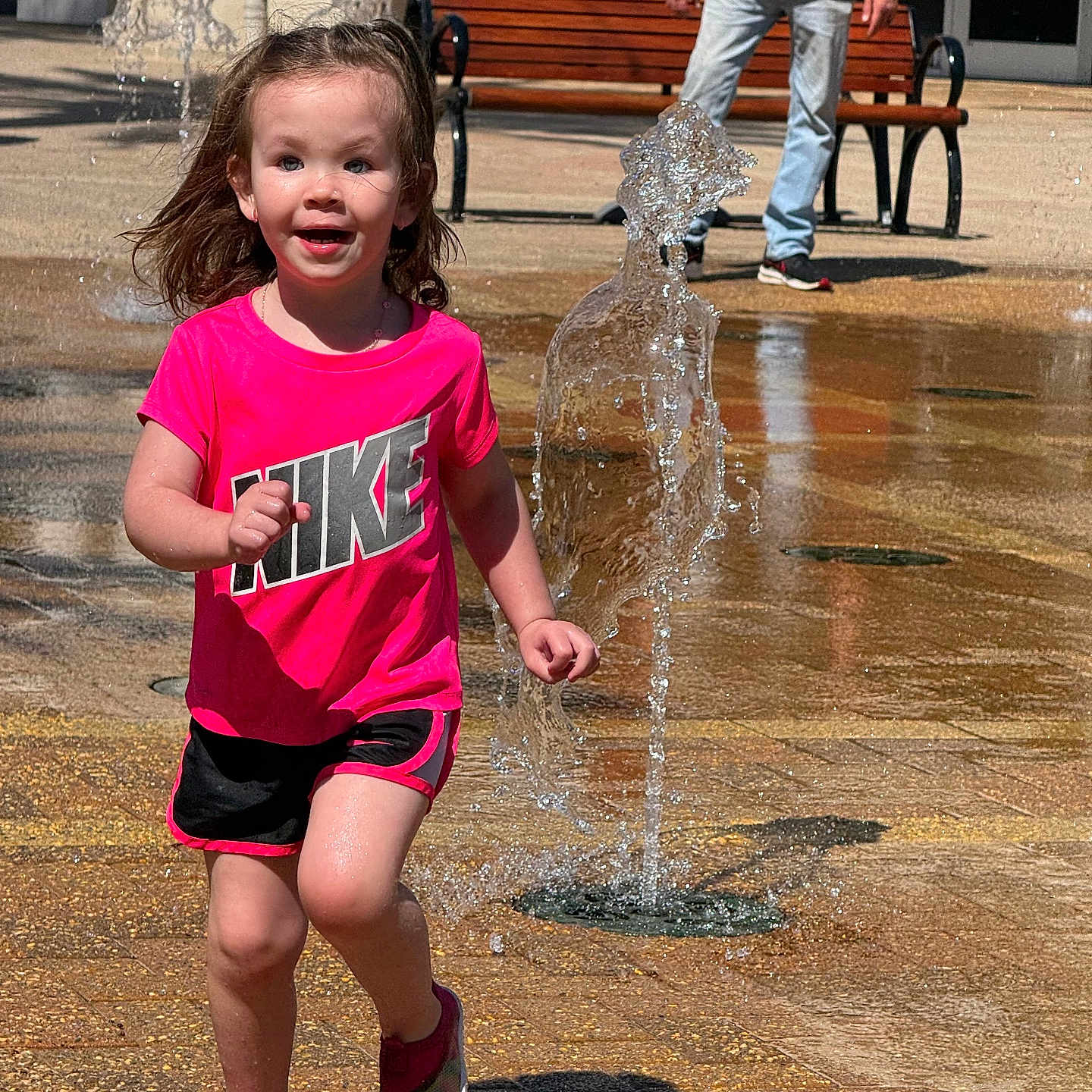 Lexi is registered to the contest to win money with this photo: architecture, bench, clothing, face, footwear, fountain, furniture, grass, head, nature, outdoors, park, person, photography, plant, portrait, shorts, summer, t_shirt, water