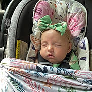 Saylor joined the competition — help win amazing prizes! baby, sleeping, car_seat, blanket, headband, bow, floral_pattern, child, infant, seatbelt, cushion, soft, indoors, cute, resting, peaceful, toddler, face, person, closeup