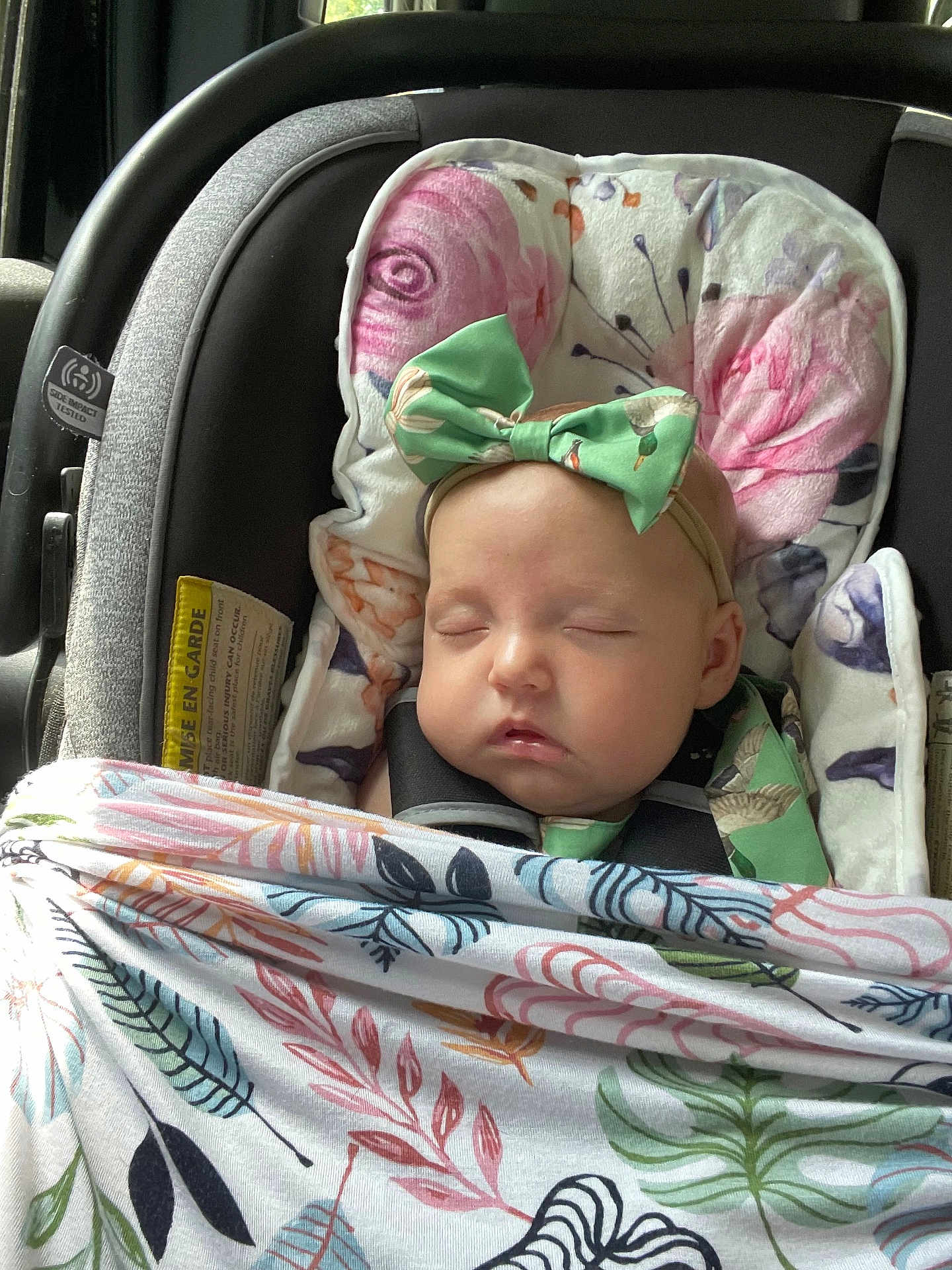 Saylor joined the competition — help win amazing prizes! baby, sleeping, car_seat, blanket, headband, bow, floral_pattern, child, infant, seatbelt, cushion, soft, indoors, cute, resting, peaceful, toddler, face, person, closeup