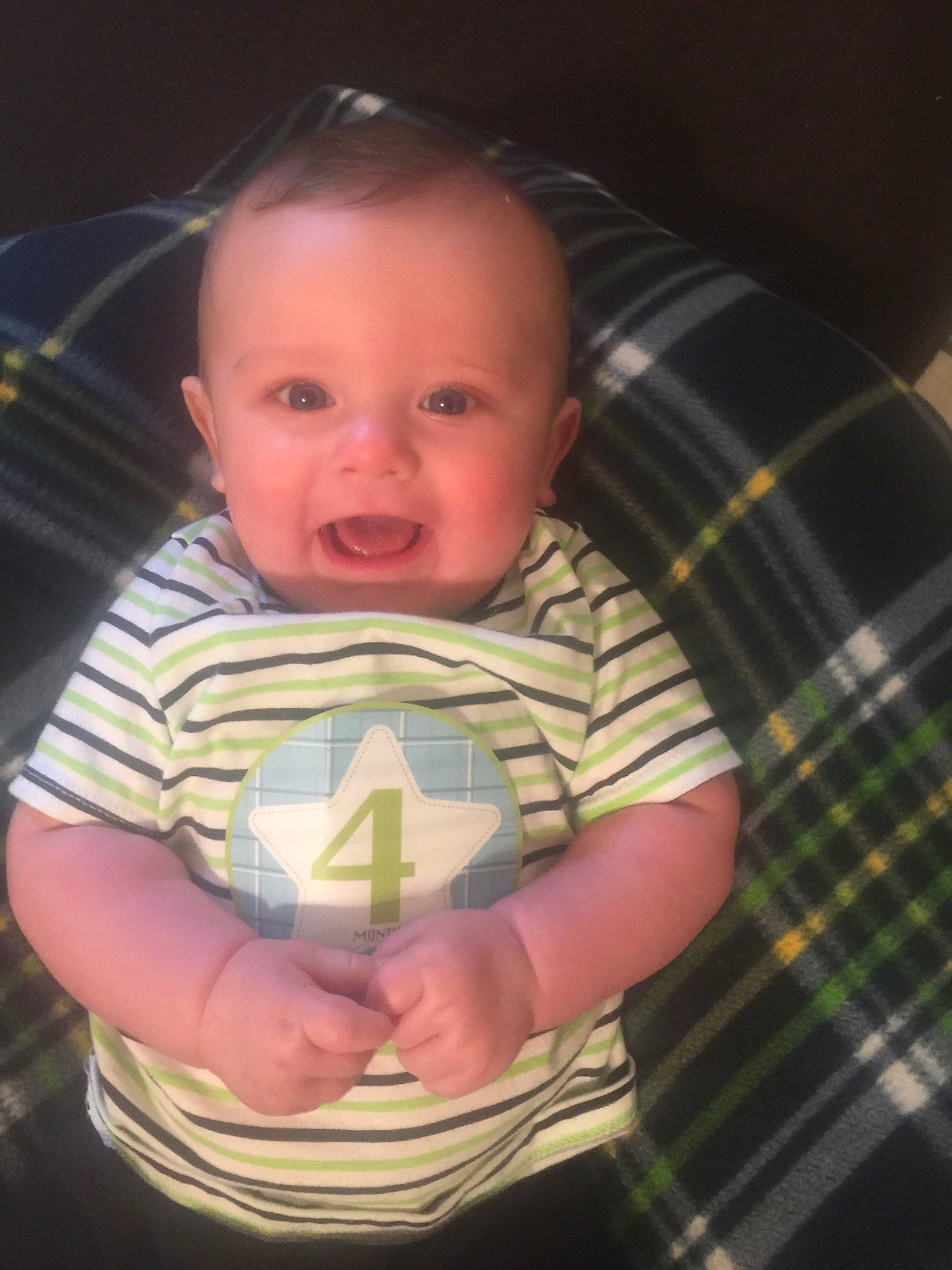 Knox Ryder Parker is registered to the contest to win money with this photo: arm, baby, cheek, child, chin, design, eye, face, head, iris, mouth, muscle, pattern, person, plaid, skin, smile, textile, toddler