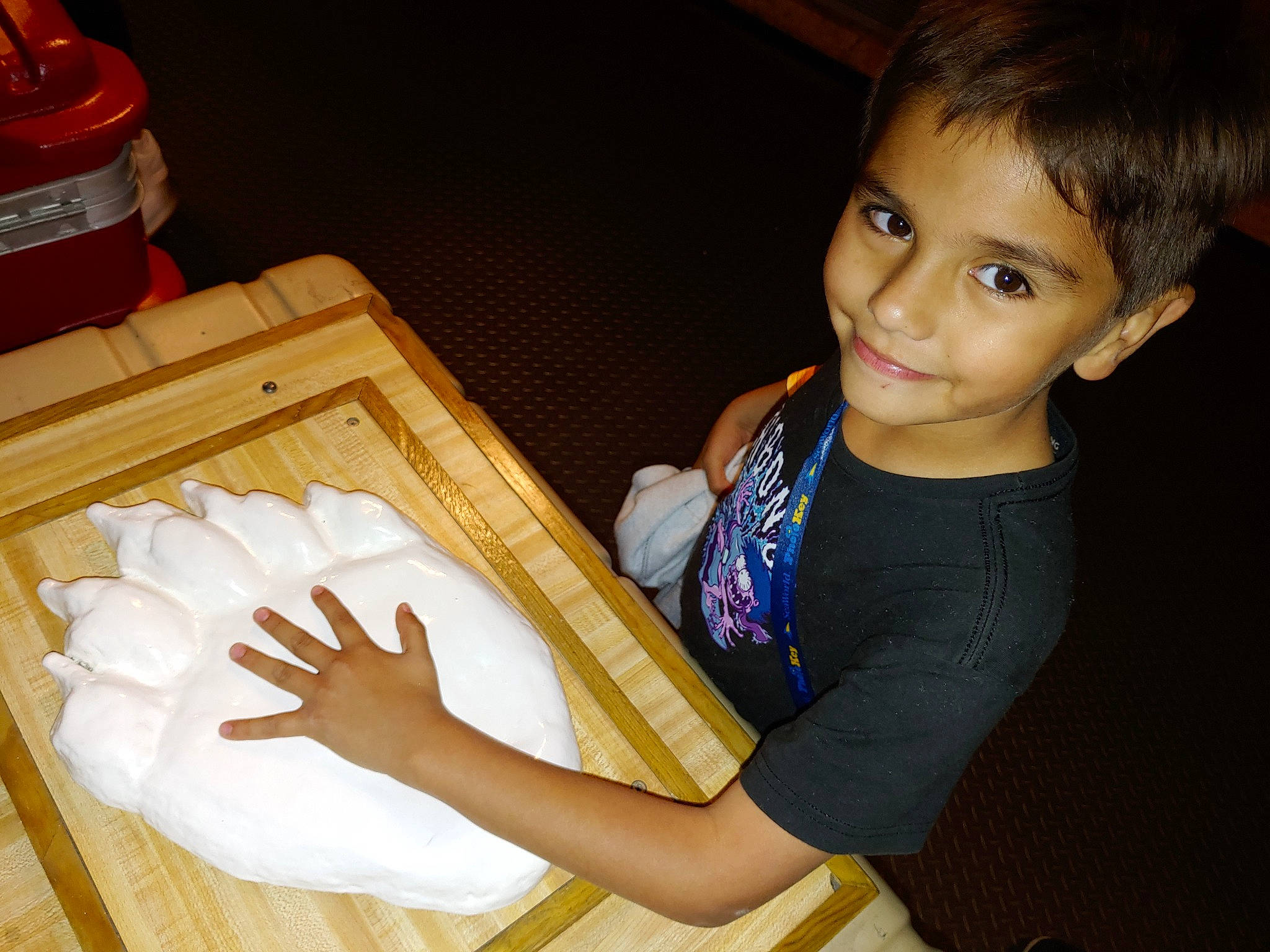 Dean is registered to the contest to win money with this photo: baby_toddler_clothing, elbow, finger, flooring, fun, gesture, hand, hardwood, joy, nail, organ, person, sleeve, smile, standing, t_shirt, thumb, toddler, varnish, wood