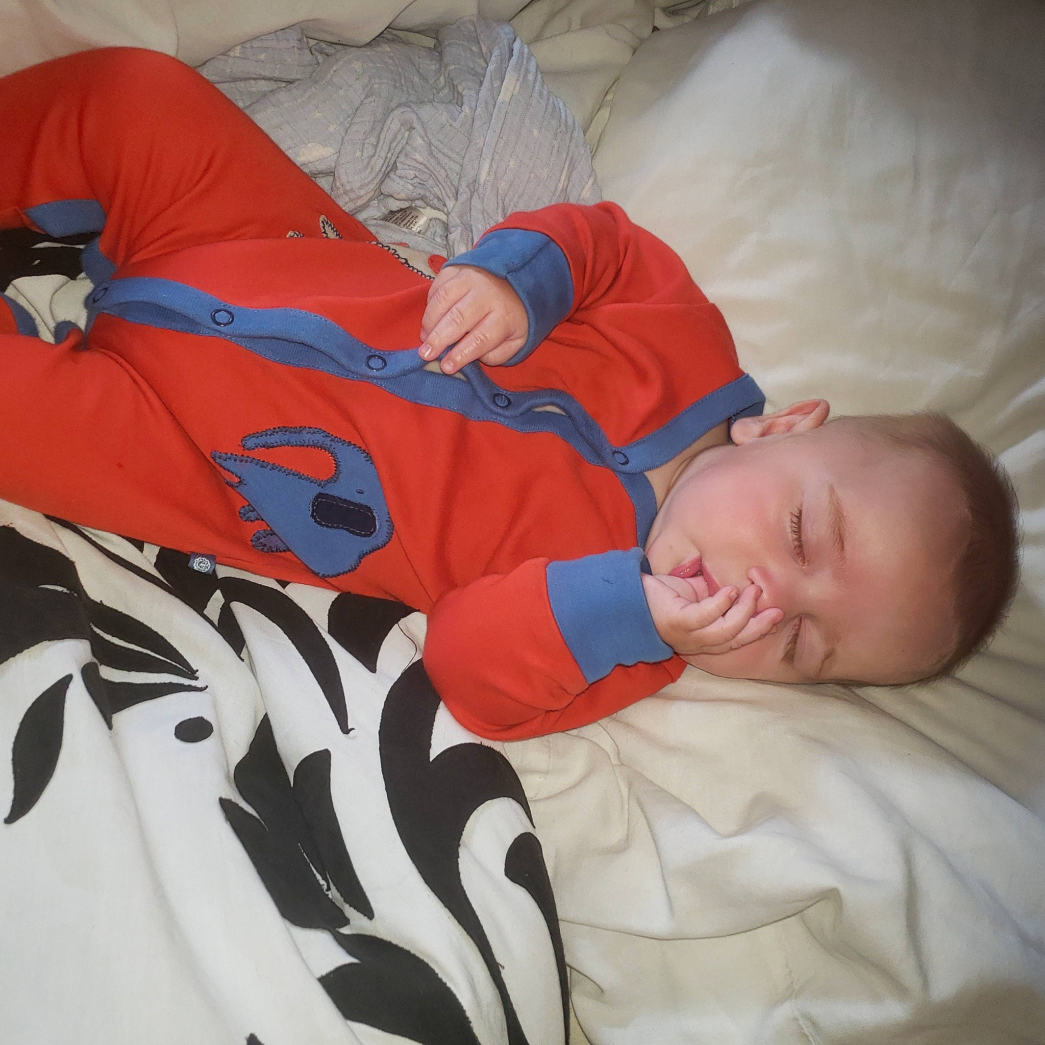 Jaxon is registered to the contest to win money with this photo: baby, baby_sleeping, baby_toddler_clothing, bedtime, carmine, child, comfort, couch, elbow, electric_blue, linens, mammal, pattern, person, room, sitting, sleeve, t_shirt, textile, toddler