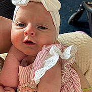 Nova joined the competition — help win amazing prizes! baby, infant, headband, bow, pink_dress, striped_clothing, ruffles, arm, person, closeup, indoor, child, cute, skin, face, expression, holding, comfort, portrait, soft_lighting