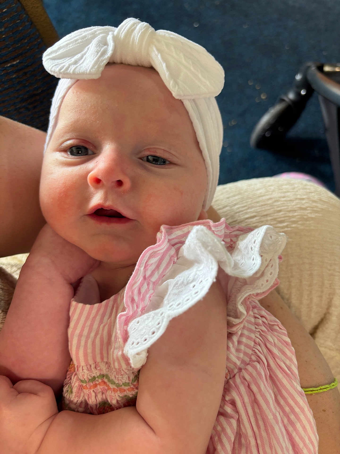 Nova joined the competition — help win amazing prizes! baby, infant, headband, bow, pink_dress, striped_clothing, ruffles, arm, person, closeup, indoor, child, cute, skin, face, expression, holding, comfort, portrait, soft_lighting