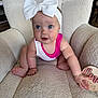 Wrenlee joined the competition — help win amazing prizes! baby, child, infant, bow, headband, pink_clothing, white_clothing, chair, furniture, indoor, cute, expression, face, hand, foot, sitting, soft_texture, curious, portrait, person