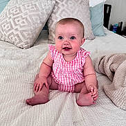 Wrenlee joined the competition — help win amazing prizes! baby, infant, smiling, pink_clothing, sitting, bed, pillows, blanket, indoor, cute, child, face, person, happy, soft_texture, home, cozy, looking, blue_eyes, naked_feet