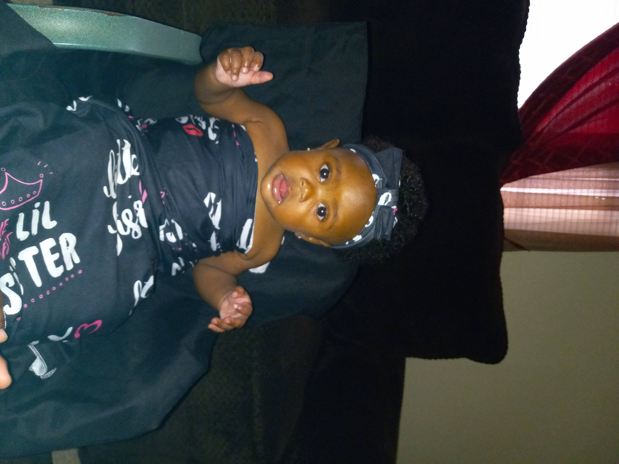 Dakota is registered to the contest to win money with this photo: baseball_cap, child, darkness, elbow, event, finger, flash_photography, fun, gesture, happy, hat, headgear, human_body, mouth, person, room, sleeve, smile, t_shirt, toddler