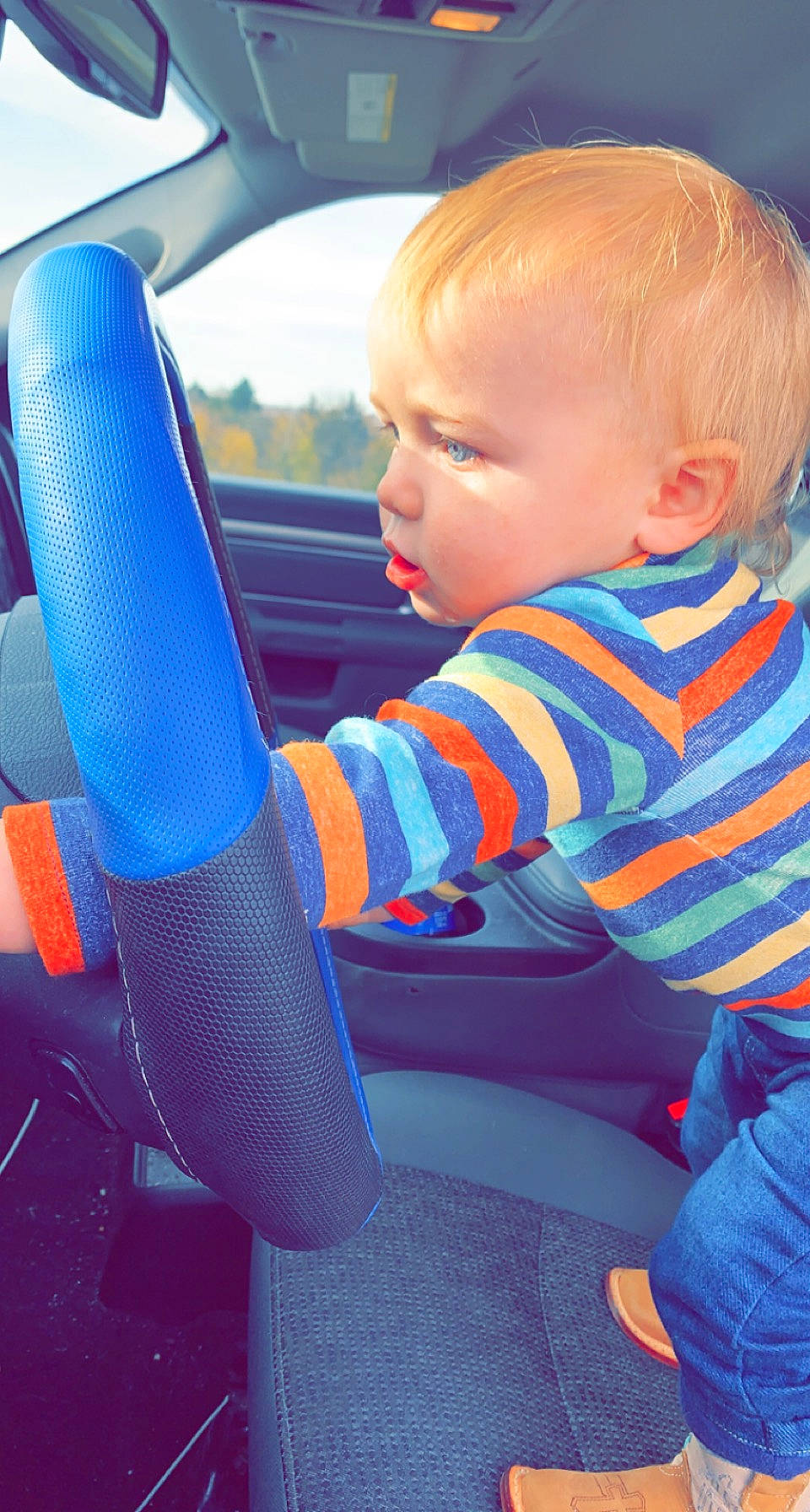 Connor John is registered to the contest to win money with this photo: automotive_design, automotive_exterior, baby_toddler_clothing, blue, car, car_seat, car_seat_cover, finger, fun, hand, human_body, leisure, motor_vehicle, person, product, steering_part, steering_wheel, toddler, vehicle, vehicle_door