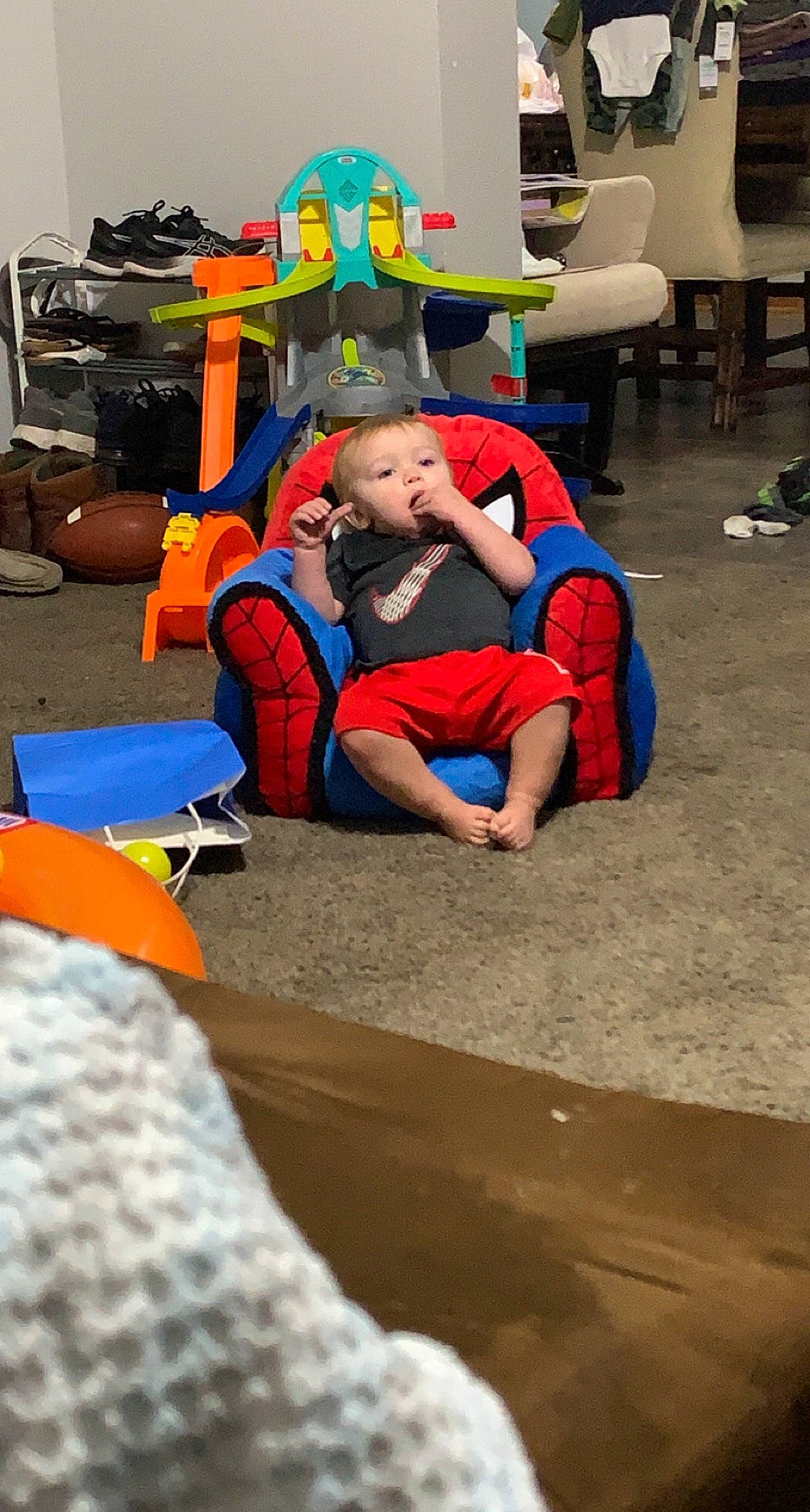 Connor John joined the competition — help win amazing prizes! backpack, bag, chair, child, competition_event, electric_blue, event, flooring, fun, leisure, luggage_and_bags, person, play, recreation, room, shoe, shorts, sitting, t_shirt, toddler