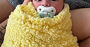 Dean joined the competition — help win amazing prizes! baby, pacifier, blanket, yellow_blanket, cozy, infant, wrapped, soft_texture, hand, gray_blanket, resting, wide_eyes, newborn, human, portrait, cute, comfort, skin, closeup, indoor