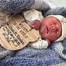 newborn, baby, infant, sleeping, blanket, hat, wooden_sign, announcement, cute, cozy, soft, clothing, face, peaceful, portrait, child, newborn_baby, resting, wrapped, indoors