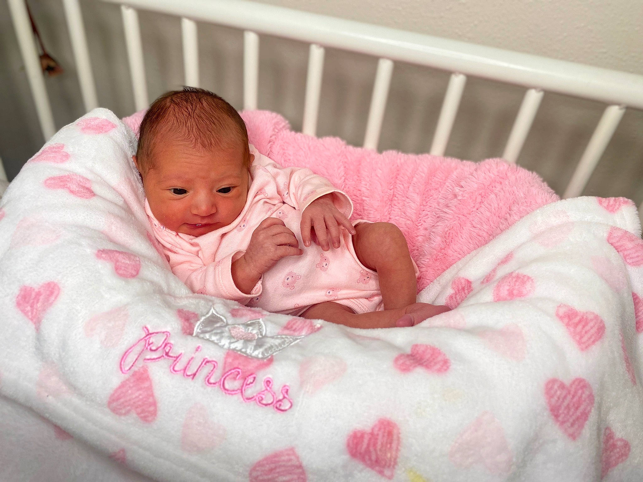 Darcy is registered to the contest to win money with this photo: baby, baby_products, baby_safety, baby_toddler_clothing, bedding, bedtime, cheek, comfort, eye, face, facial_expression, head, infant_bed, linens, mammal, person, pink, product, skin, textile