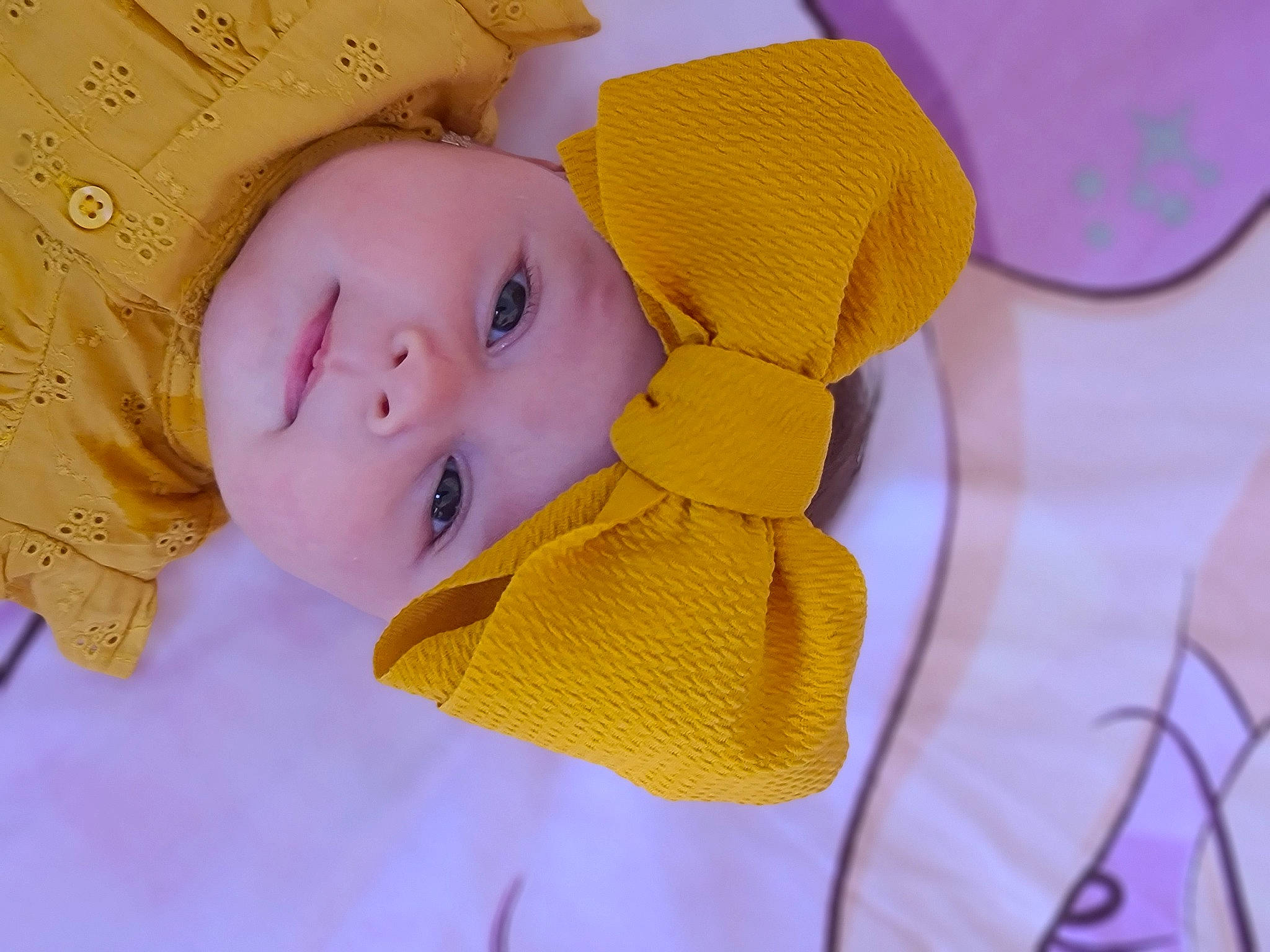 Amalia joined the competition — help win amazing prizes! baby, baby_products, baby_sleeping, baby_toddler_clothing, cheek, child, fashion_accessory, hair_accessory, happy, headwear, linens, magenta, material_property, pattern, person, petal, purple, skin, textile, toddler