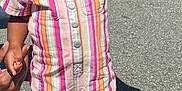 Maleah is registered to the contest to win money with this photo: toddler, child, smiling, outdoor, holding_hands, striped_clothing, romper, pink_shoes, sunny, sidewalk, adult_hands, short_hair, earrings, playful, walking, street, grass, daytime, casual, happy