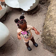 Maleah joined the competition — help win amazing prizes! toddler, child, outdoor, concrete, hair_ties, minnie_mouse, clothing, footwear, sculpture, eggshell, playground, curious, standing, nature, rocks, dirt, shorts, black_shoes, pink, braids