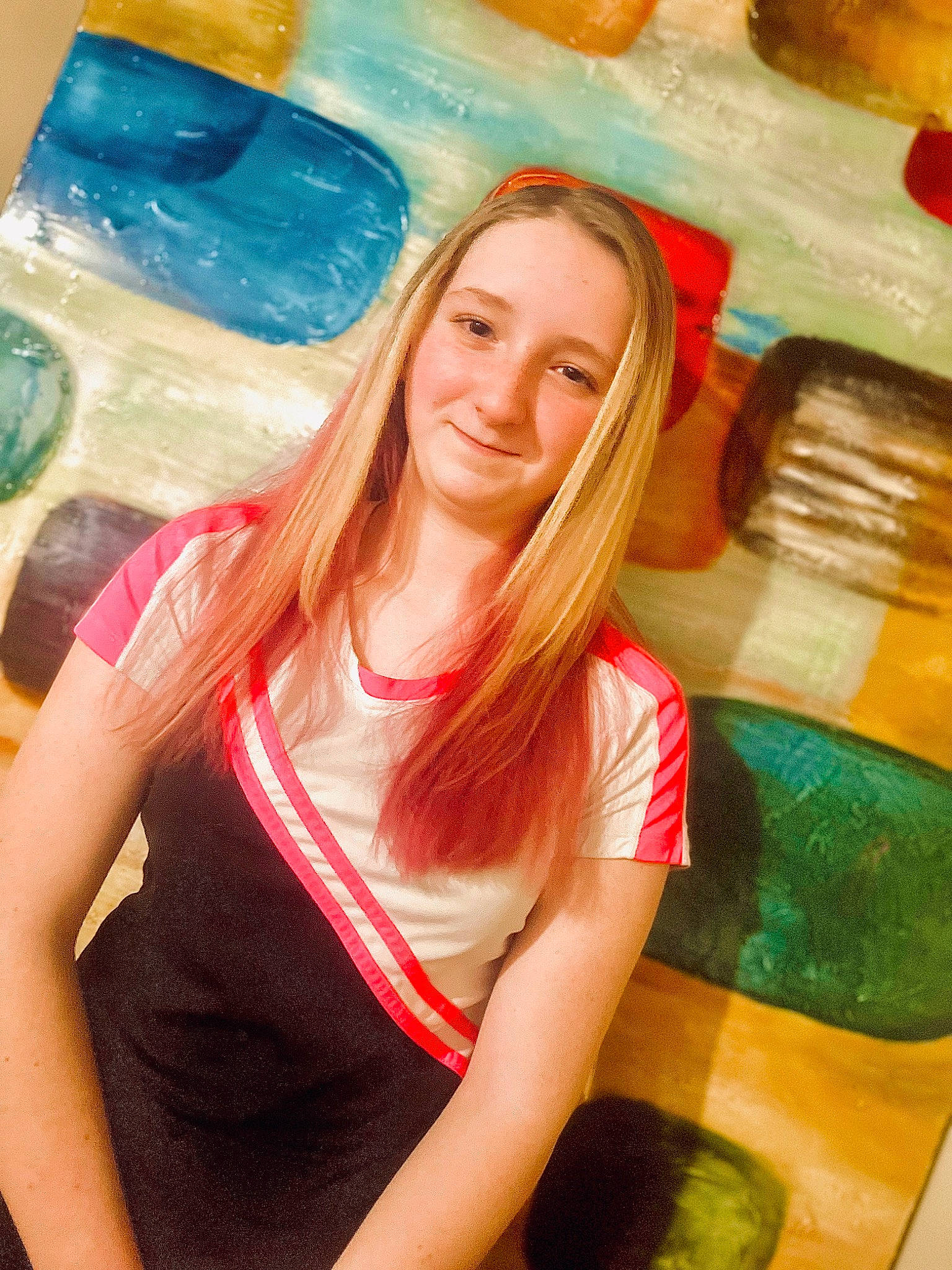 Jaida is registered to the contest to win money with this photo: blond, brown_hair, chair, cool, electric_blue, fun, glass, happy, human_leg, joy, leisure, long_hair, paint, pattern, person, recreation, sitting, smile, t_shirt, thigh