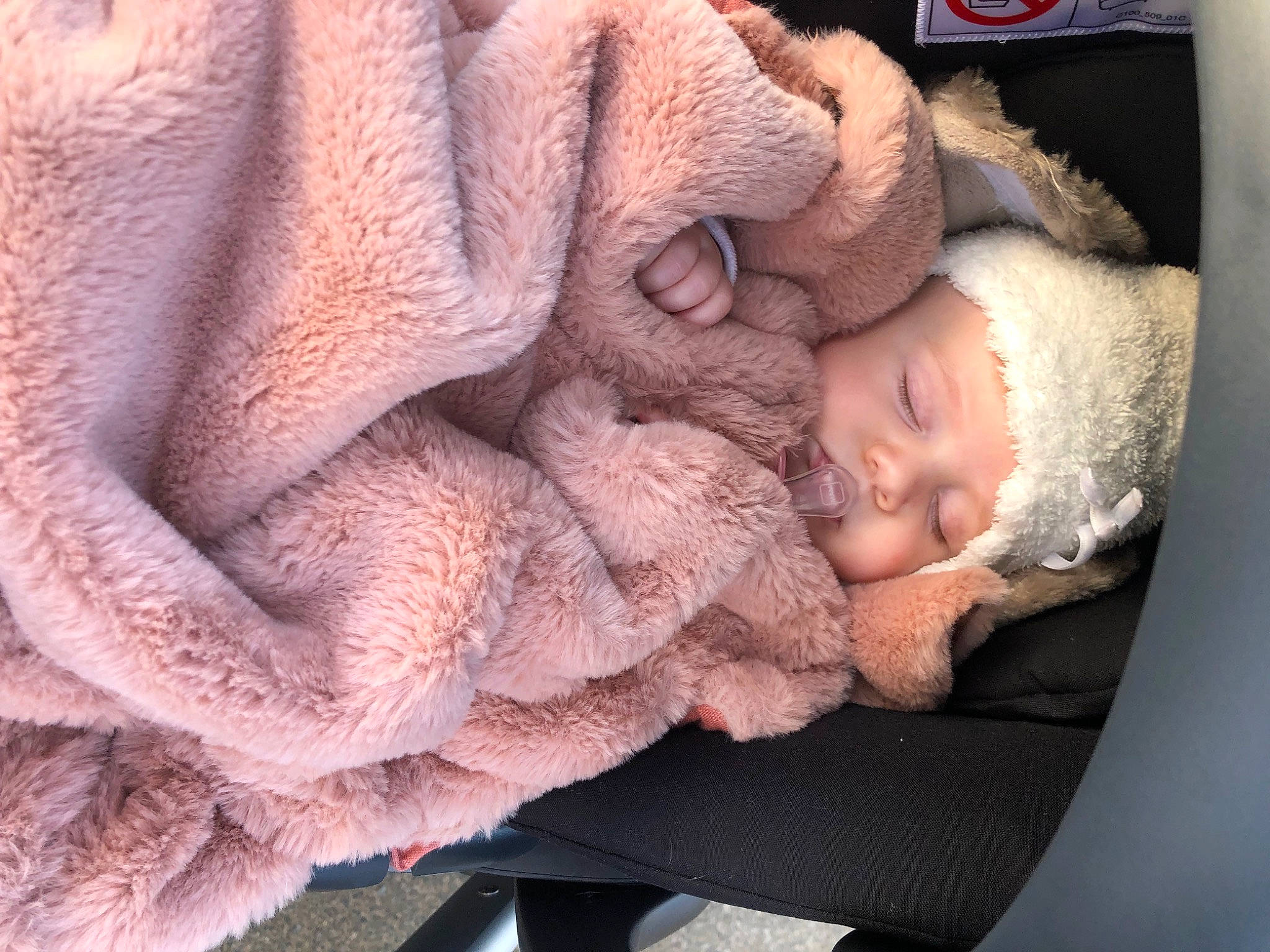 Romy participe au concours pour gagner de l'argent avec cette photo : baby, baby_products, baby_sleeping, car_seat, cheek, chin, comfort, ear, fur, headgear, headwear, knit_cap, linens, peach, person, skin, textile, thread, toddler, wool