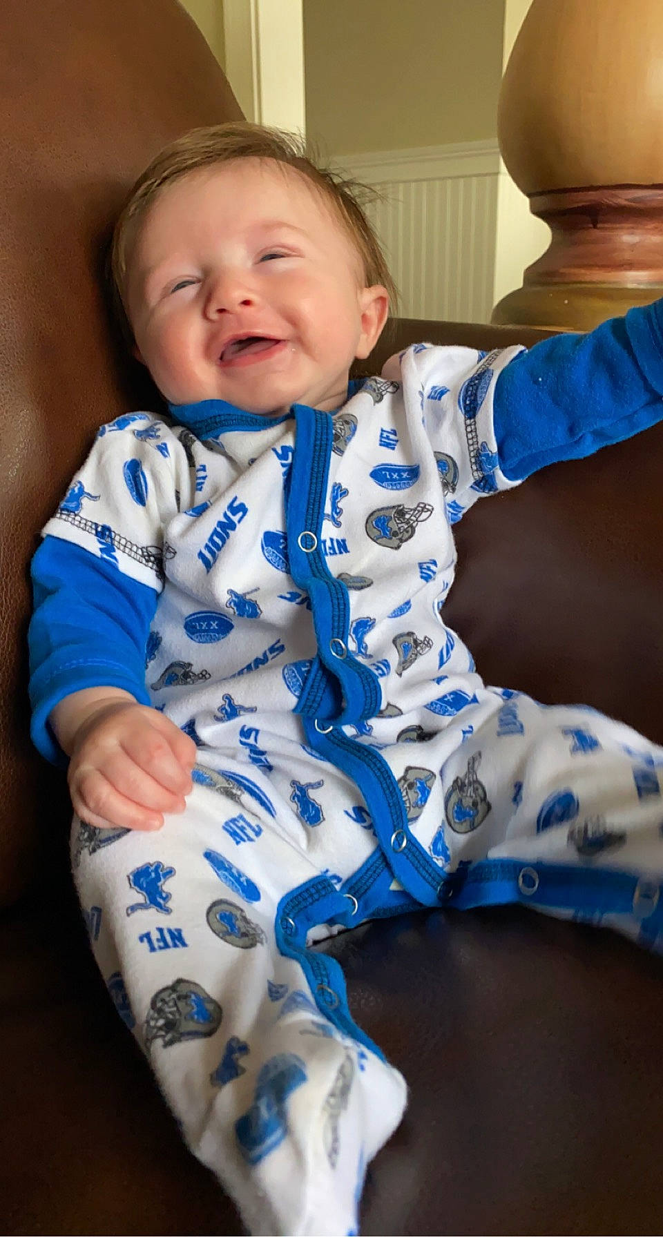 Dallas is registered to the contest to win money with this photo: arm, azure, baby_toddler_clothing, cheek, eye, face, facial_expression, finger, gesture, hand, happy, head, joint, neck, organ, person, skin, sleeve, smile, standing