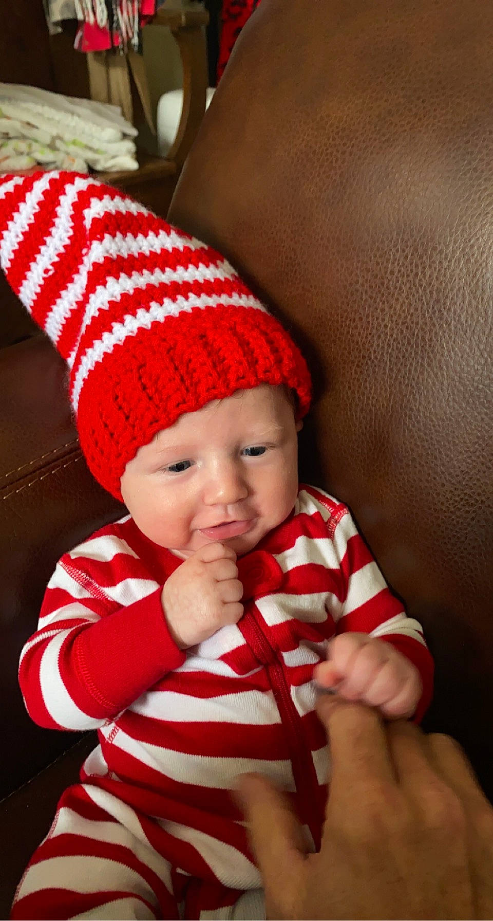Dallas is registered to the contest to win money with this photo: baby, baby_toddler_clothing, beanie, cap, carmine, child, christmas, christmas_eve, comfort, costume_hat, couch, event, fashion_accessory, headwear, holiday, knit_cap, pattern, person, sleeve, toddler