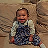 Maia is registered to the contest to win money with this photo: baby, child, infant, smiling, sitting, sofa, couch, portrait, indoors, home, floral_dress, hair_bow, white_shirt, socks, curly_hair, happy, mirror, furniture, cozy, photography