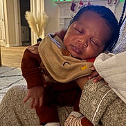 Jnari joined the competition — help win amazing prizes! baby, sleeping, infant, bib, clothing, hand, person, indoor, living_room, sofa, blanket, footwear, socks, cozy, peaceful, home, television, decor, carpet, furniture