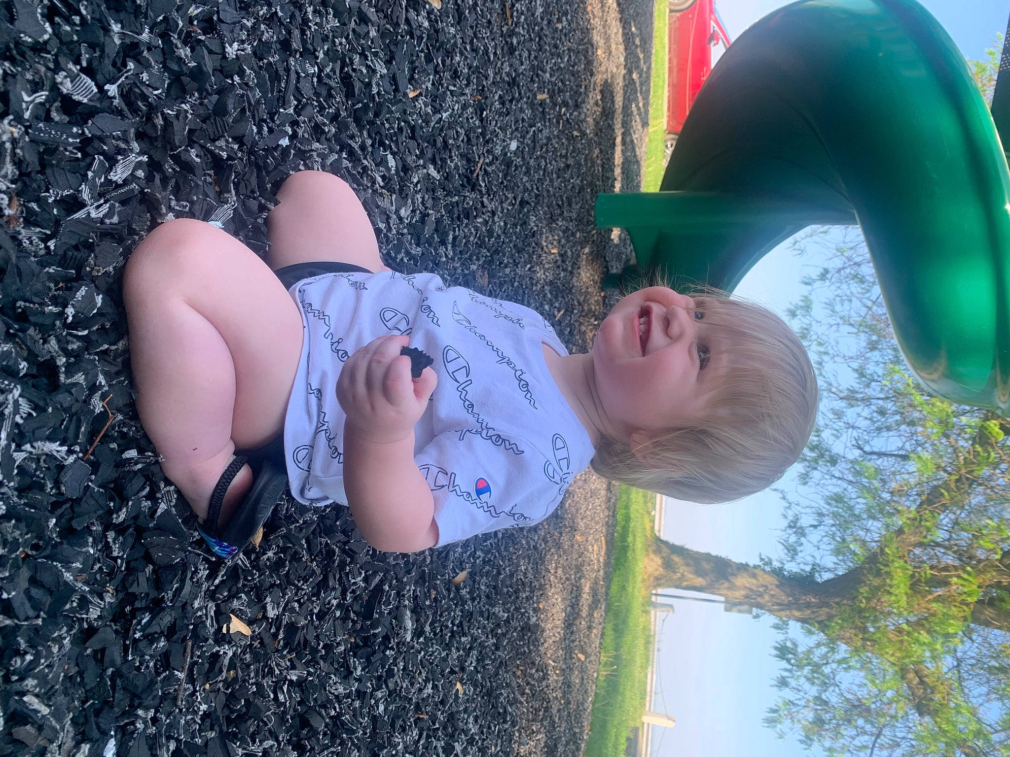 Adalynn is registered to the contest to win money with this photo: azure, botany, facial_expression, finger, grass, green, hand, happy, hat, joy, leisure, light, organ, people_in_nature, person, plant, smile, thigh, tree, water