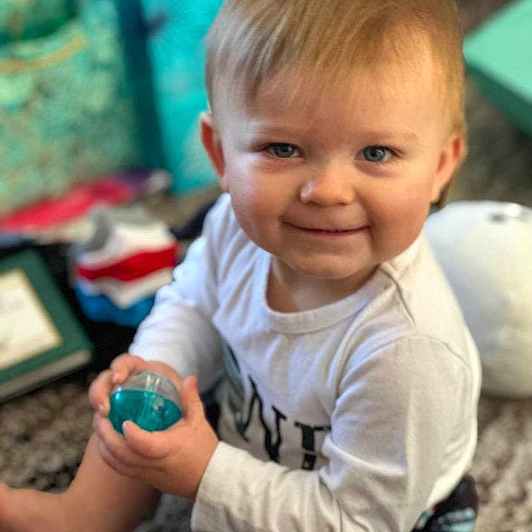 Malcolm is registered to the contest to win money with this photo: ball, blonde, boy, child, clothing, face, football, hair, happy, head, male, person, photography, portrait, sitting, smile, soccer, soccerball, sport, t_shirt